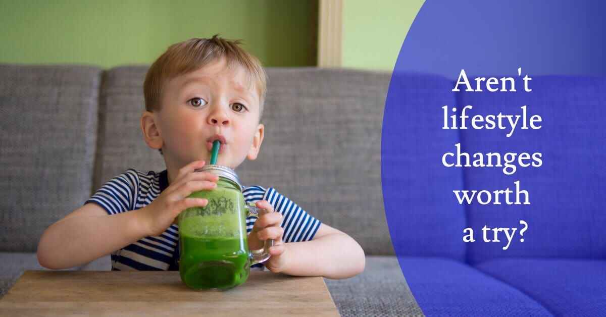 Boy drinking a green smoothy